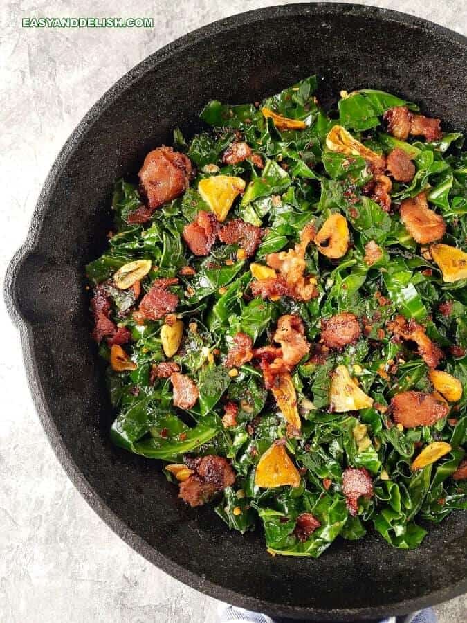 a skillet with fried collard greens and bacon