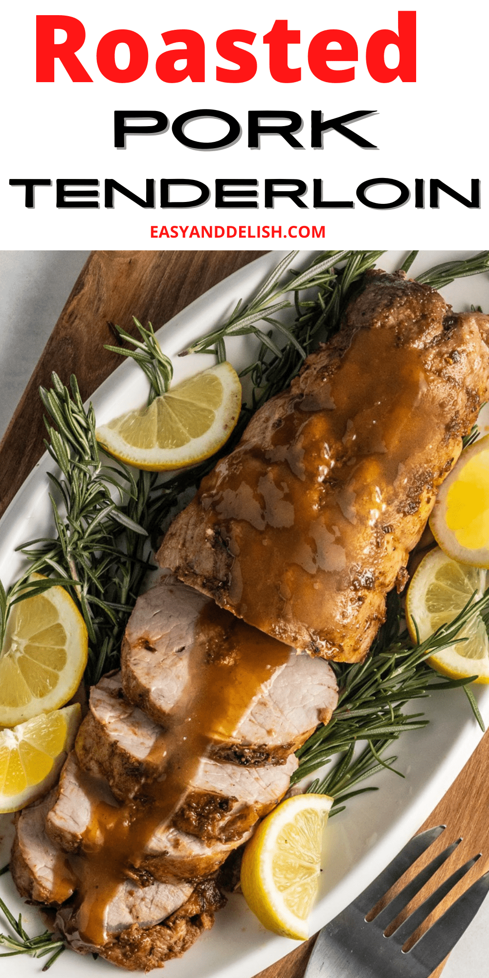 Close up of roasted pork tenderloin garnished with lemon and rosemary.