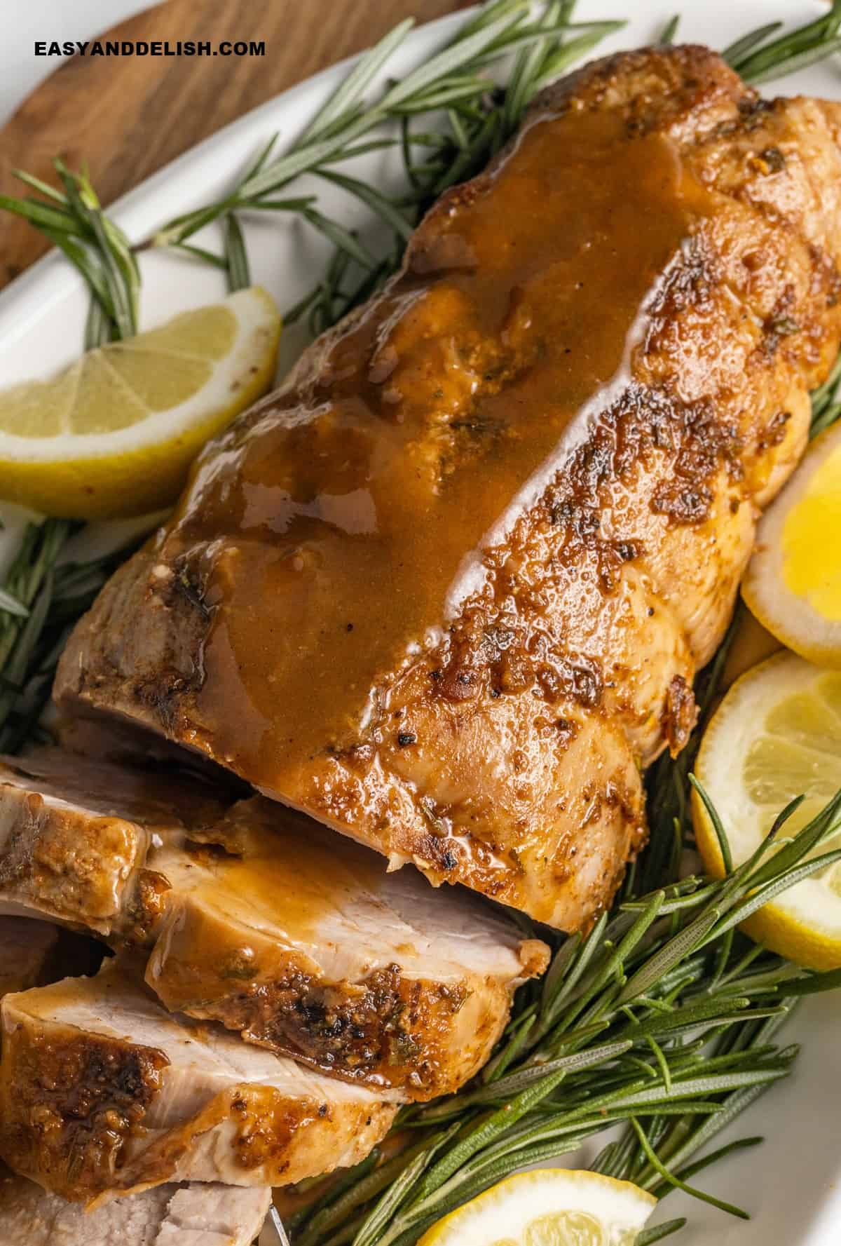 close up of roasted Smithfield pork loin  partially sliced in a platter.