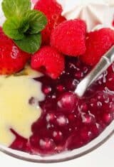 close up of red wine tapioca pudding in a glass with creme anglaise