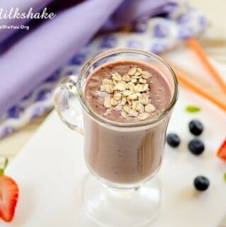 acai milkshake in a clear coffee cup