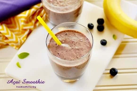 acai smoothie in a glass with fruits on the side 