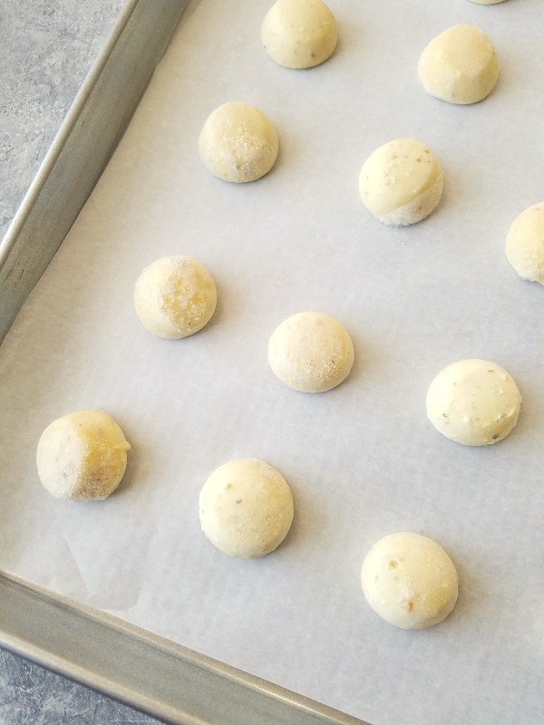 unbaked rolls on a baking sheet to bake