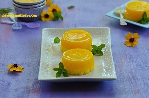 Two bright yellow round quindim custards on a plate