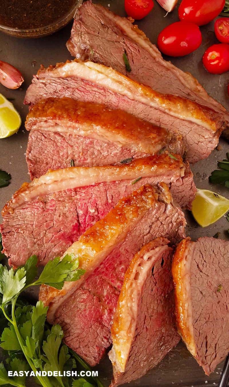 sliced oven baked rump cover or culotte with garnishes 