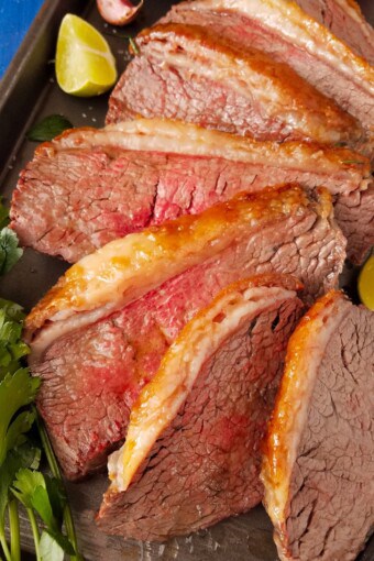 sliced picanha roast in a baking pan