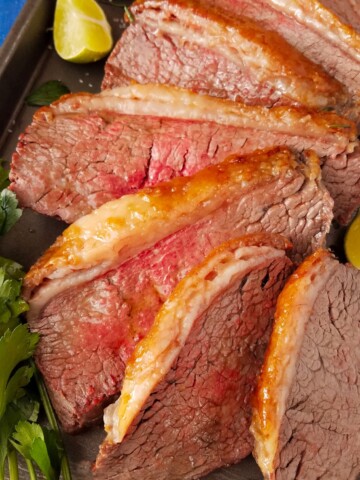 sliced picanha roast in a baking pan