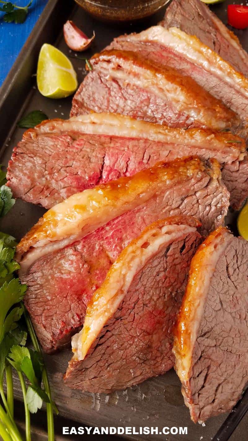 sliced picanha roast in a baking pan