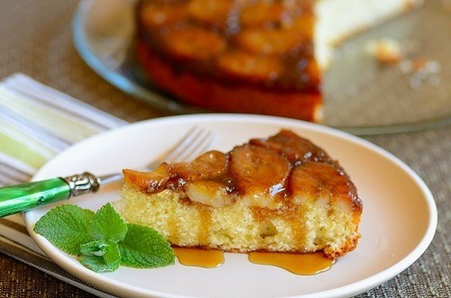 Slice of cinnamon spiced banana cake on a white plate