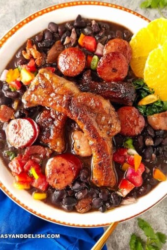 a bowl of Feijoada with orange slices