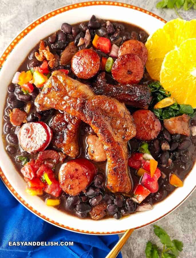a bowl of Feijoada with orange slices