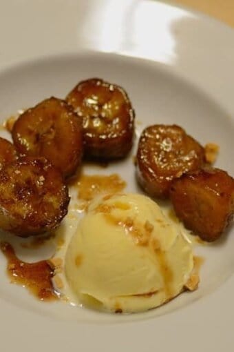 caramelized bananas with a scoop of vanilla ice cream on a plate