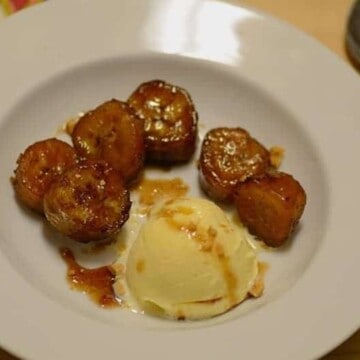 caramelized bananas with a scoop of vanilla ice cream on a plate