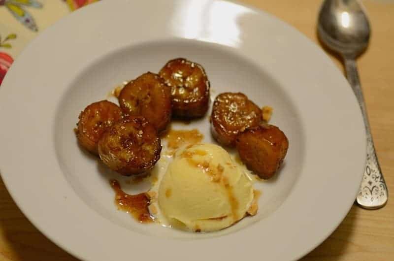 caramelized bananas with a scoop of vanilla ice cream on a plate