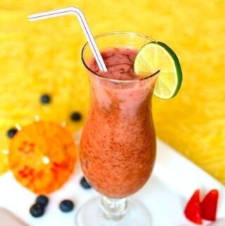 fruit cocktail in a serving glass with a bent straw