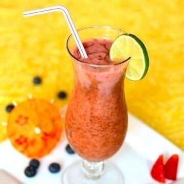 fruit cocktail in a serving glass with a bent straw