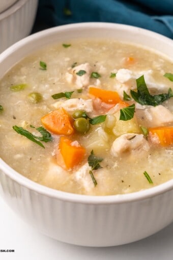 close up of a bowl of chicken and rice soup (canja de galinha)