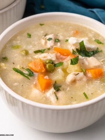 close up of a bowl of chicken and rice soup (canja de galinha)