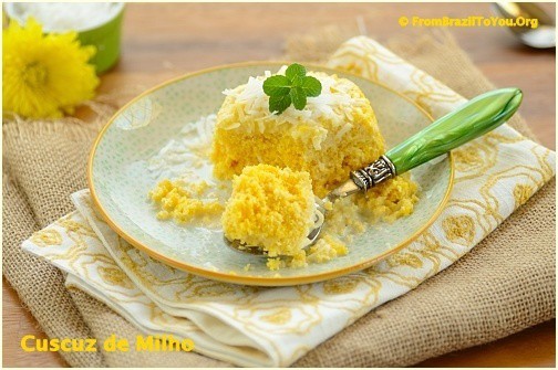 cuscuz doce (sweet cornmeal) partially eaten with a fork on the plate