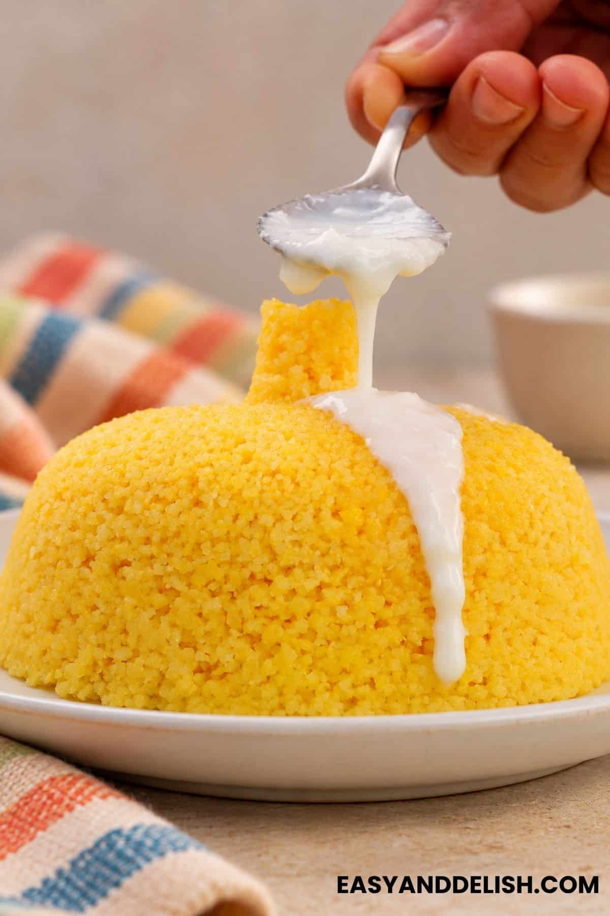 Coconut mixture spooned over Cuscuz.