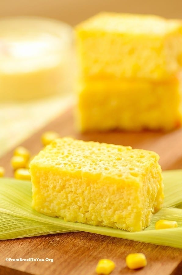 Squares of pamonha yellow corn cake on a serving board