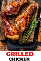 close up of grilled chicken drumsticks with herbs and spices on a cutting board