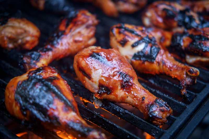 chicken legs on a charcoal grill