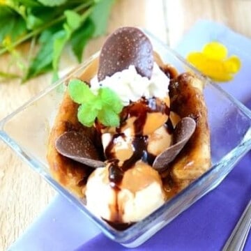 Banana split with chocolate sauce in a glass dish