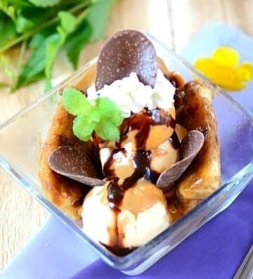 Banana split with chocolate sauce in a glass dish