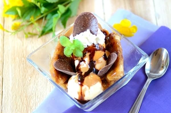 Banana split with chocolate sauce in a glass dish