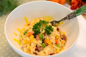 A bowl of rice with herbs on top