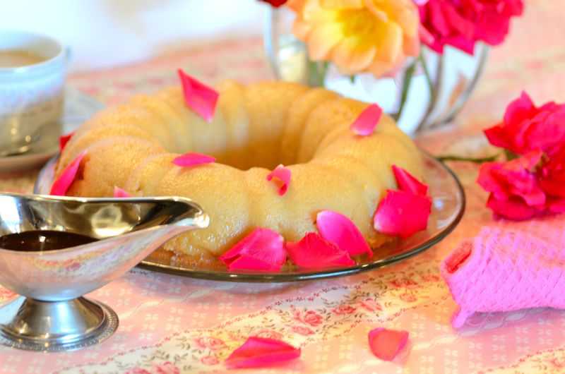 Ring of easy bread pudding or pudim de pão on a plate with rose petals