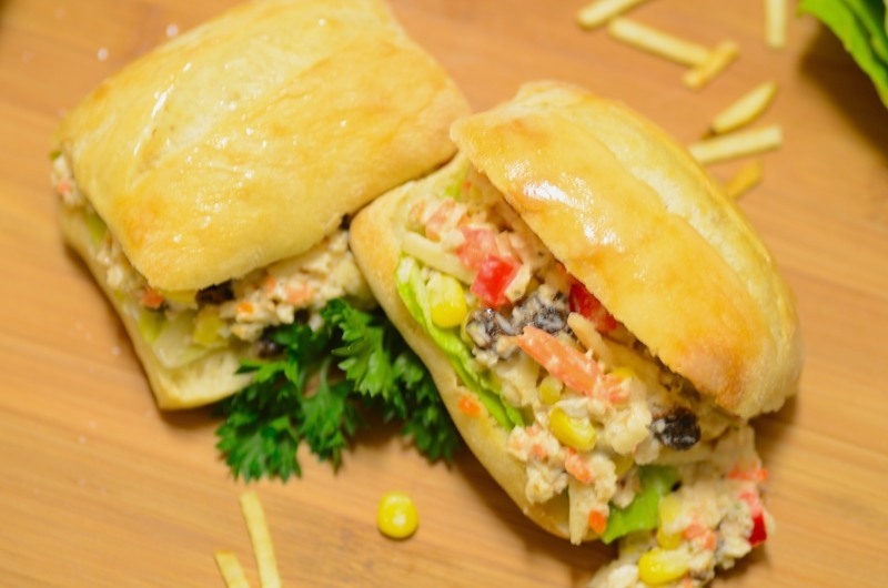 Sandwiches sitting on top of a wooden table