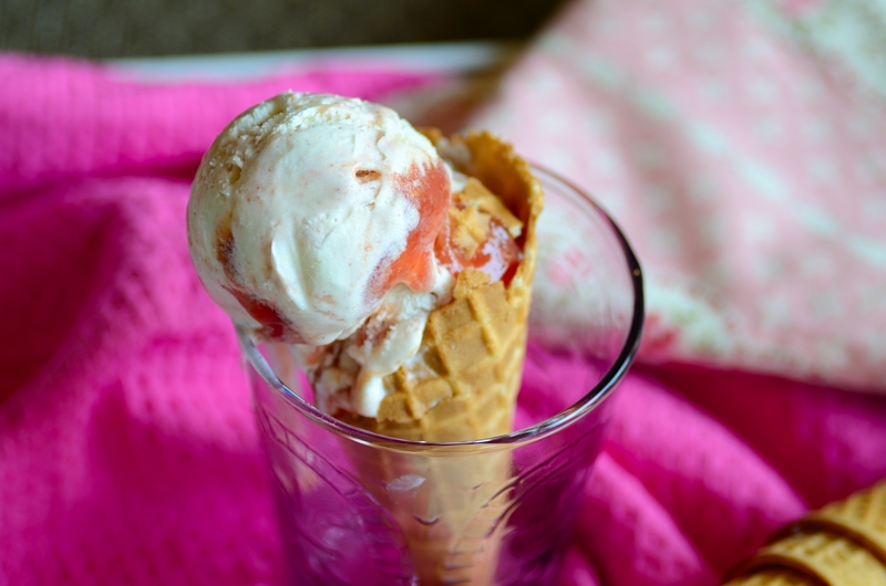 A close up of guava ice cream in a cone