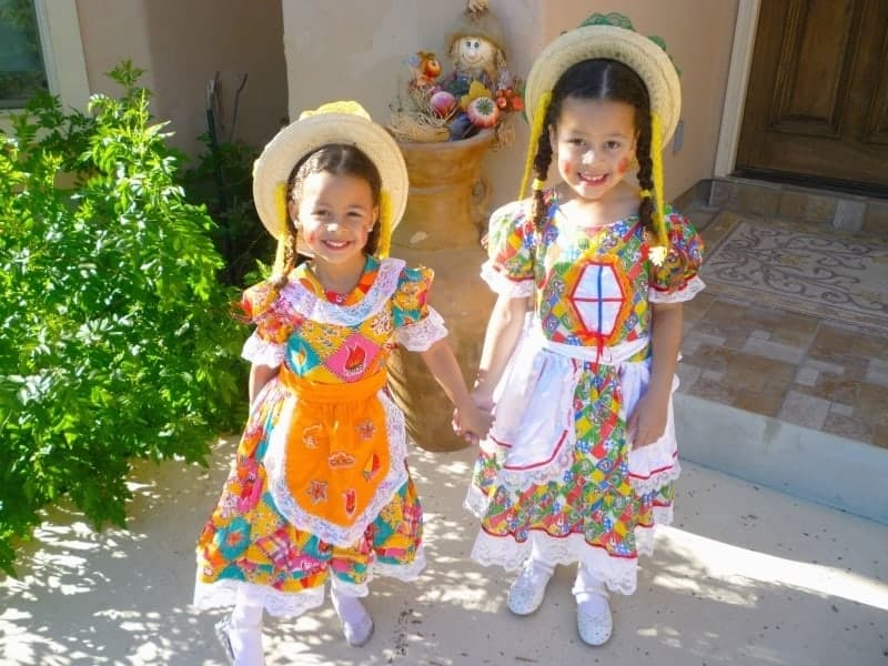 Two little girls standing in front of Halloween decoration