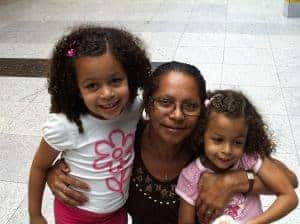 Two girls posing for a picture with an adult woman