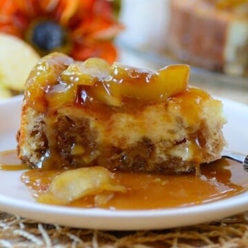 A plate of cheesecake with apple and caramel topping