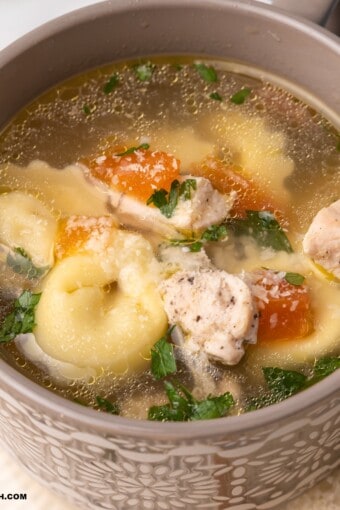 close up of a bowl of chicken tortellini soup