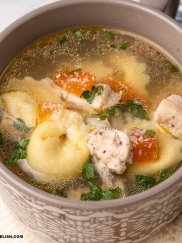 close up of a bowl of chicken tortellini soup