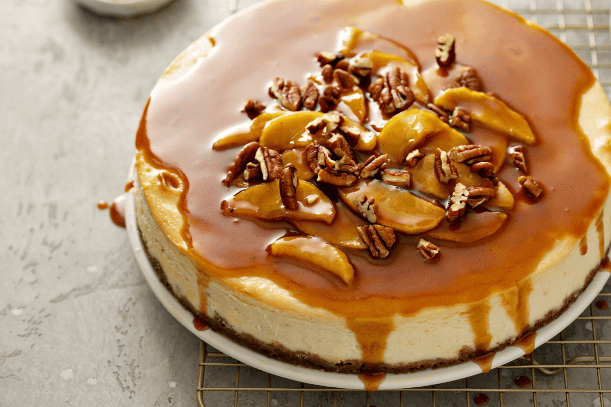close up of a low-carb caramel apple cheesecake with dripping sauce.