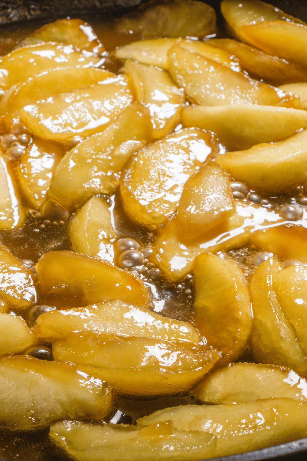 cooking apple slices cooking in a skillet.