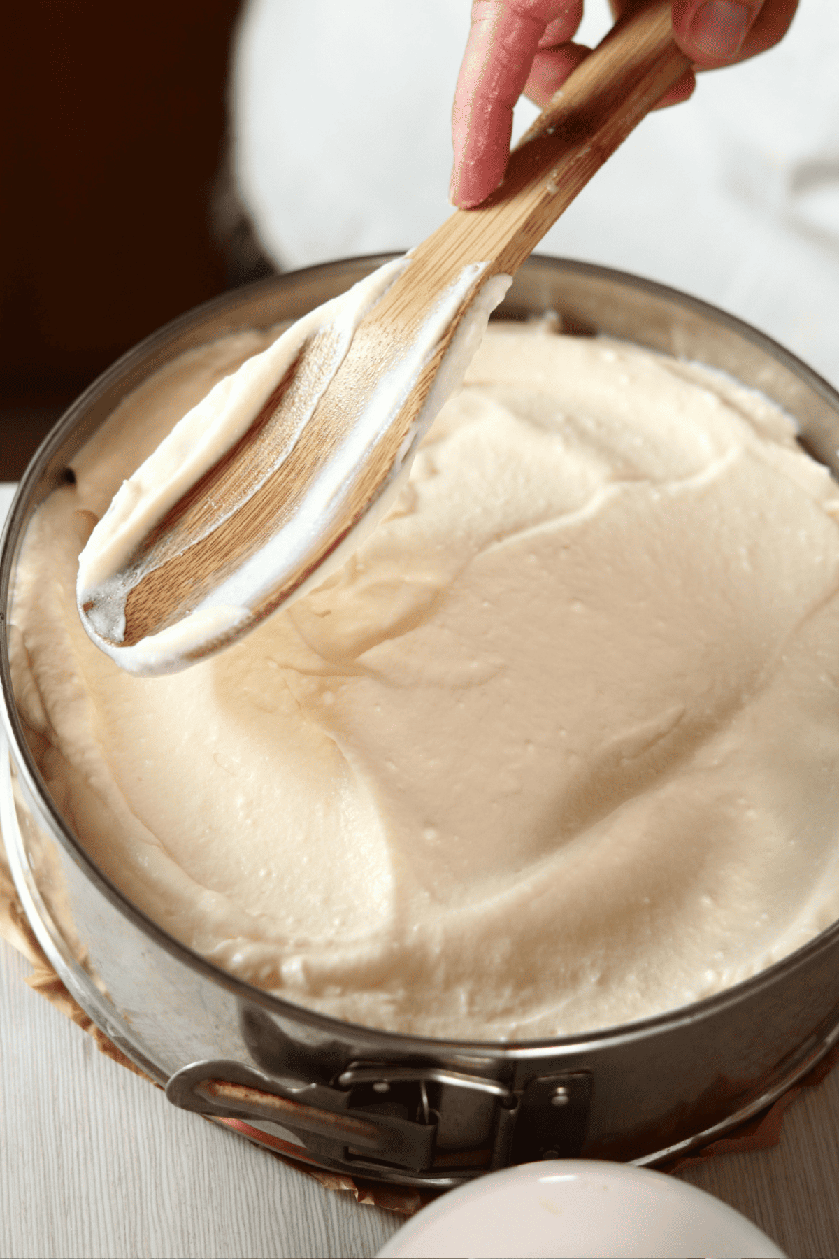 spreading filling in a cheesecake pan.