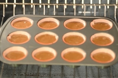 A close up of brigadeiro cupcakes being baked in a tin