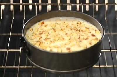 A cheesecake being baked in the oven