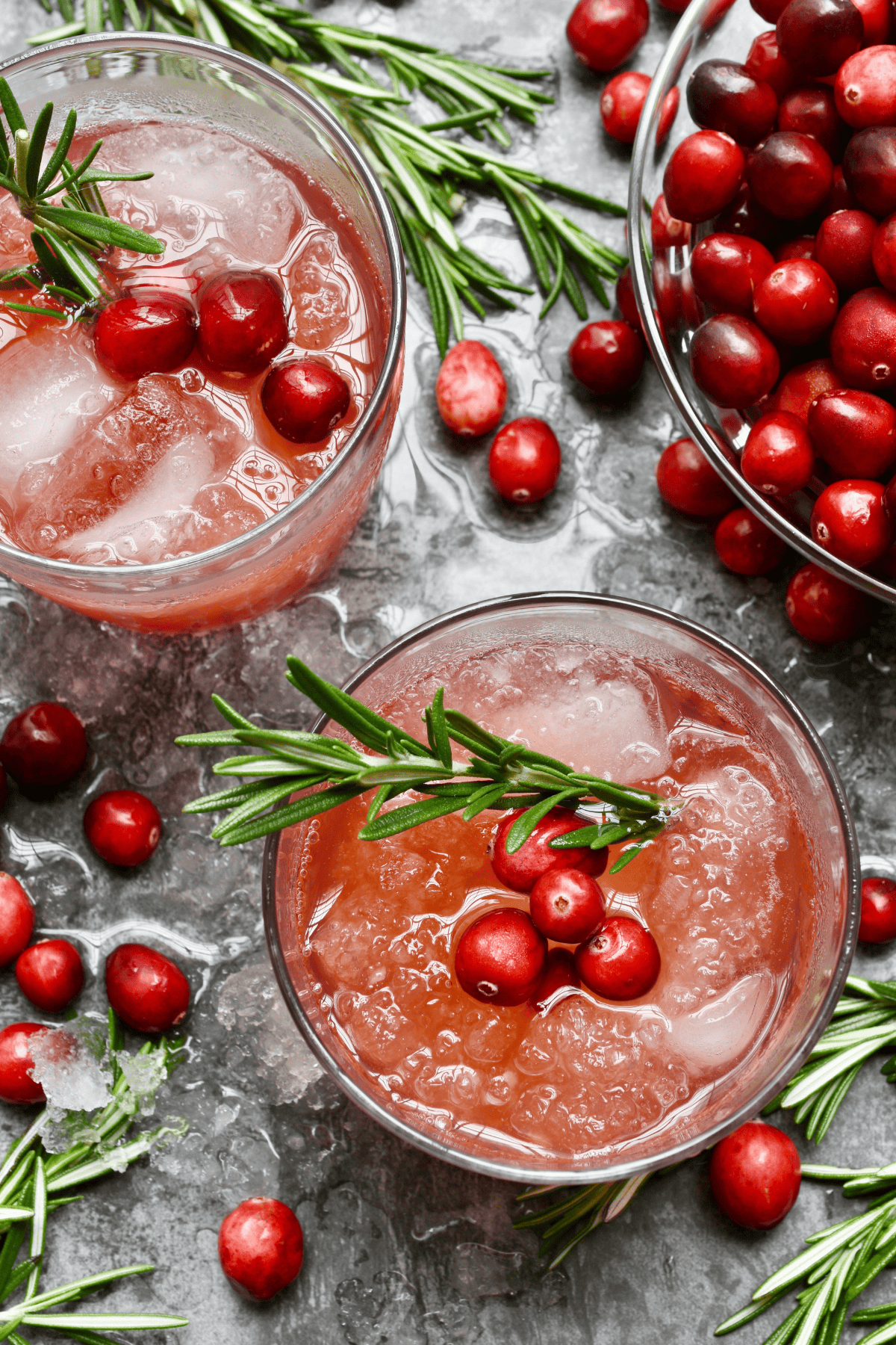 Glasses of a holiday alcoholic drink with fresh garnishes.  