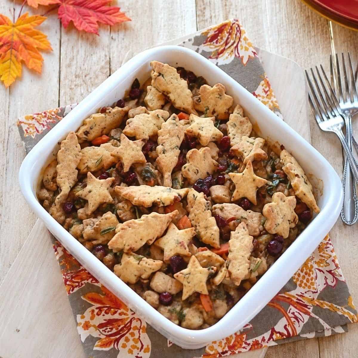 Turkey pot pie topped with crisp cranberry pecan pastry cutouts.