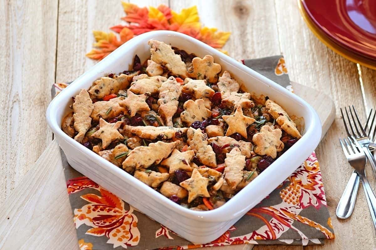 Golden pastry cutouts arranged over creamy turkey filling in a baking dish.