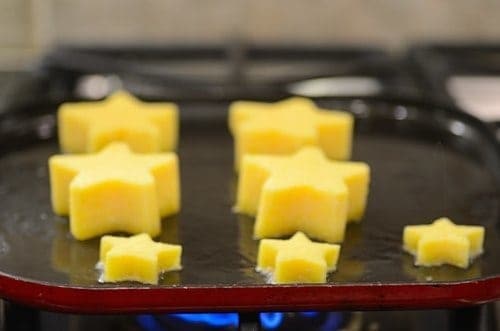 star-shape polenta being fried in a pan