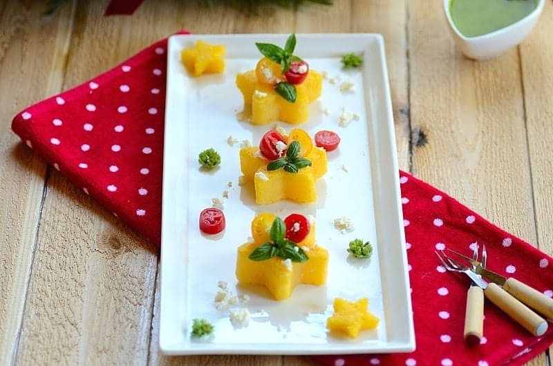 Christmas fried polenta cakes with fresh toppings in a platter.
