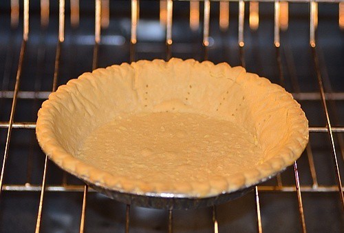 A close up of a pie crust in the oven